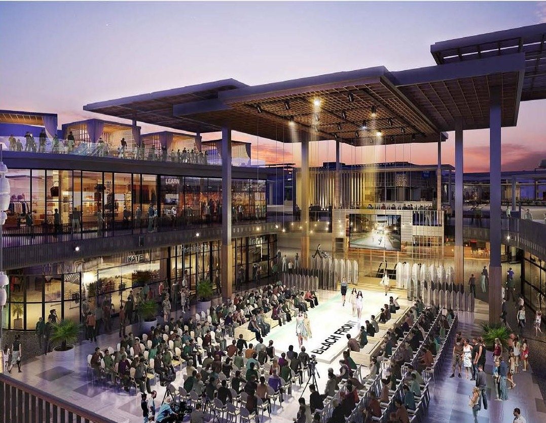 Evening event on the Westfield Century City rooftop terrace with a runway, seated audience, and the illuminated steel trellis canopy overhead